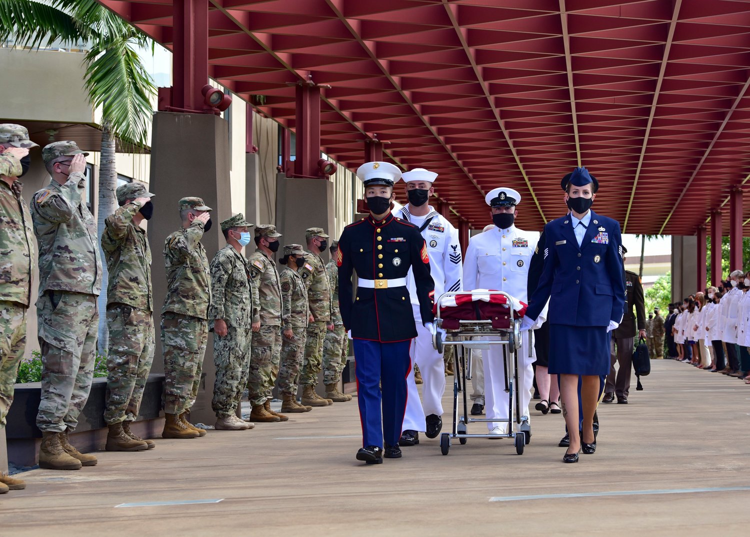 Members of the Defense POW/MIA Accounting Agency render honors Sept. 21, 2021, during a chain of custody event at Joint Base Pearl Harbor-Hickam, Hawaii, for the recently identified remains of Father Emil J. Kapaun, a Wichita, Kan., diocesan priest who laid down his life as a military chaplain during the Korean War.